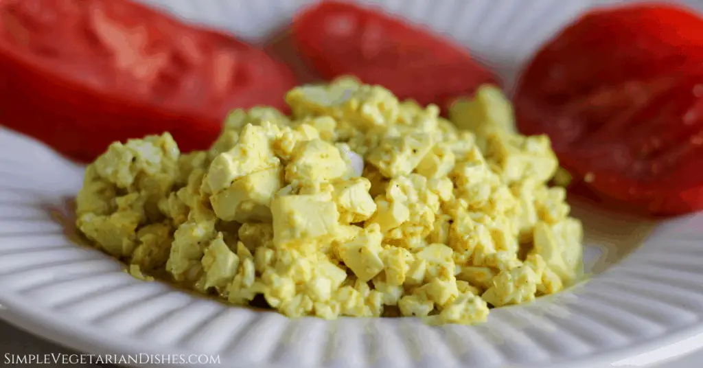 silken tofu scramble plated with salted tomatoes