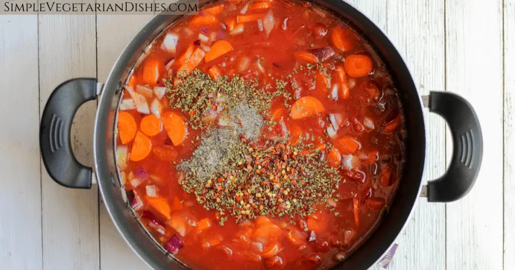Mediterranean soup base oregano red pepper black pepper carrots tomatoes onions in pot