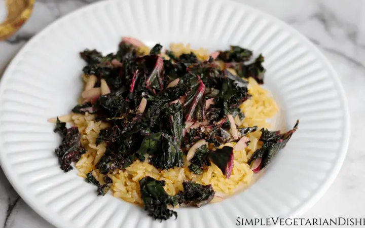 purple kale and slivered almonds on brown rice pilaf on white plate