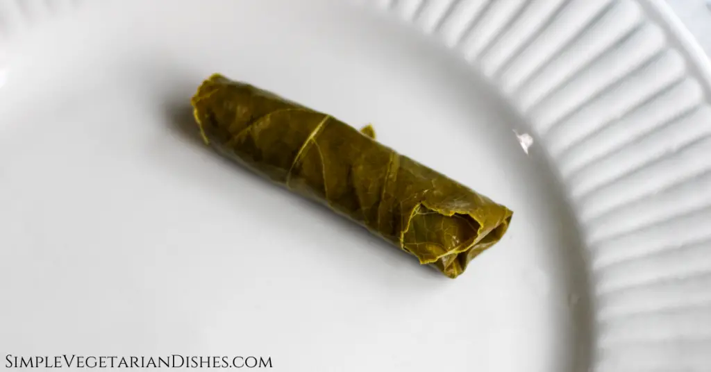 stuffed grape leaf dawali on white plate