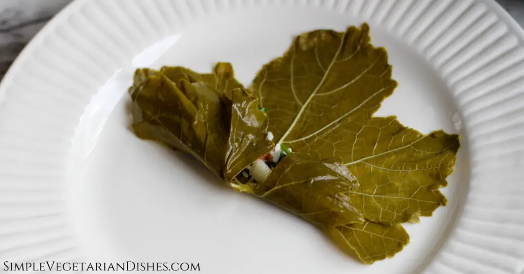 grape leaf with bottom flaps rolled up over the dawali filling