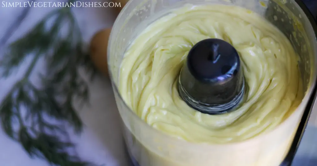 homemade mayonnaise done in food processor with dill in background to be used for harissa aioli