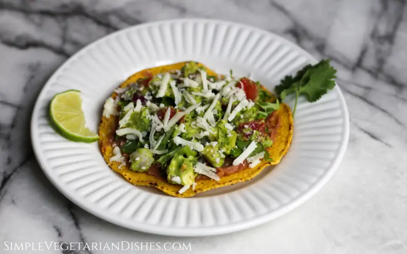 tostaguac on white plate on white marble table