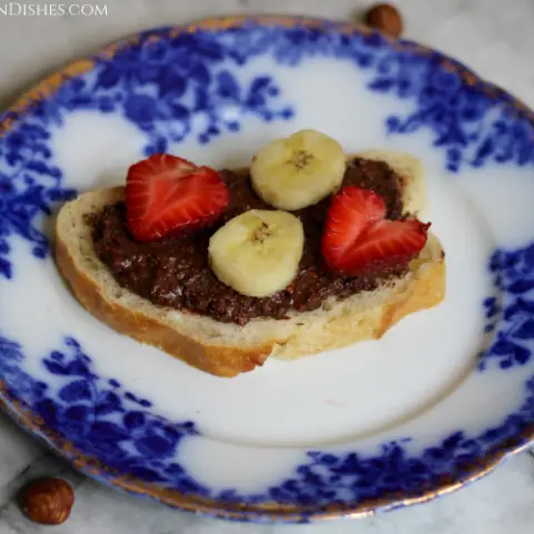 gianduja served on bread with strawberry and banana slices