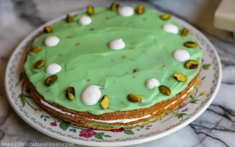 pistachio torte garnished with cool whip and whole pistachios