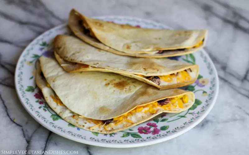three air fried quesadillas served on floral plate