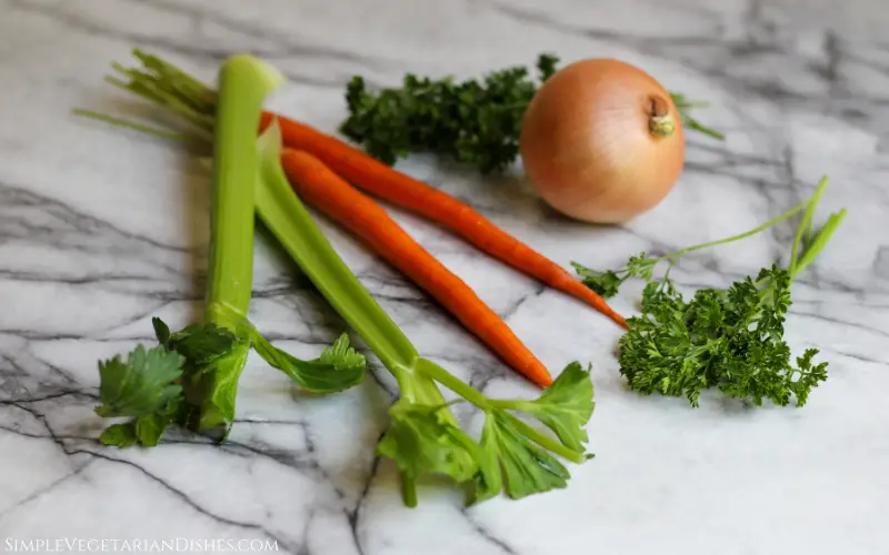 odori celery carrot onion parsley ingredients for battuto on white marble table