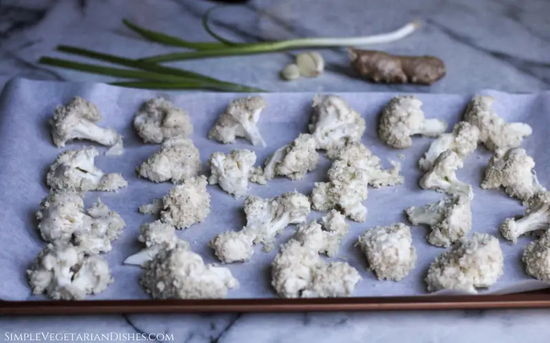 baking sheet full of breaded vegan wings unbaked