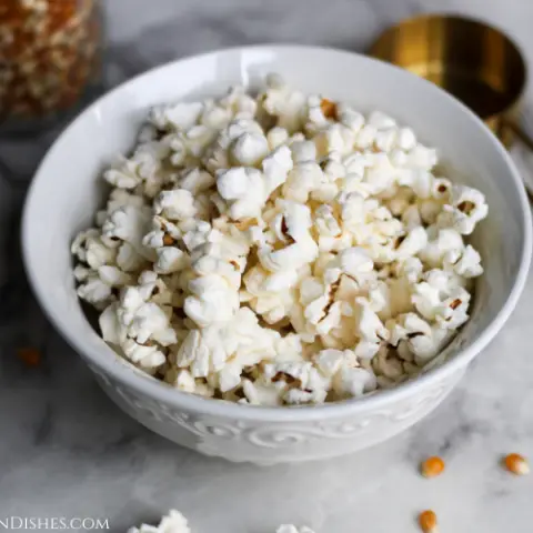air fryer popcorn served in white bowl on marble table