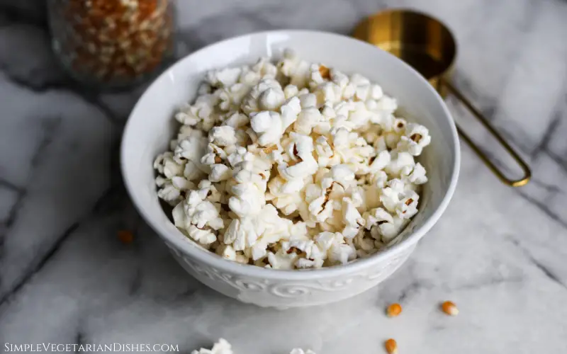 air fryer popcorn served in white bowl on marble table