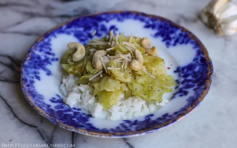 instant pot cabbage served over rice topped with vegan parmesan cheese and cashews