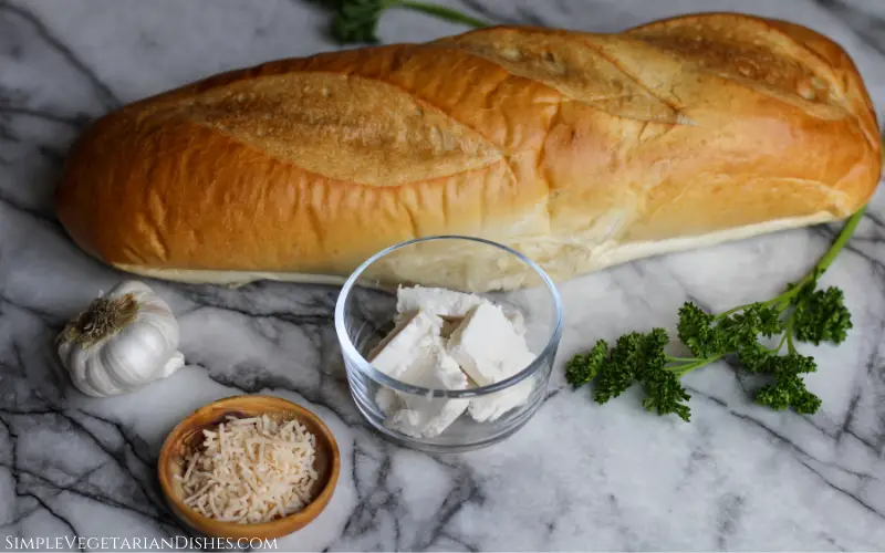 baguette parsley butter garlic parmesan cheese on white marble table
