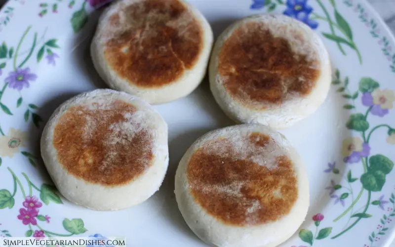 four vegan English muffins served on floral plate