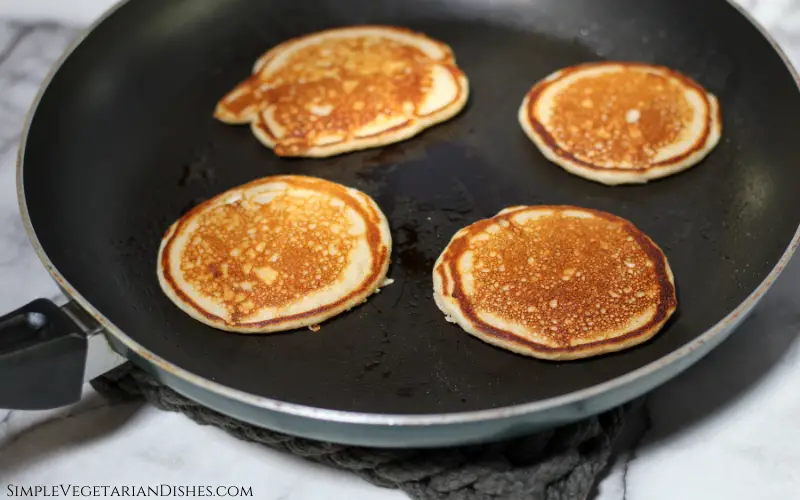 four flapjacks in black skillet