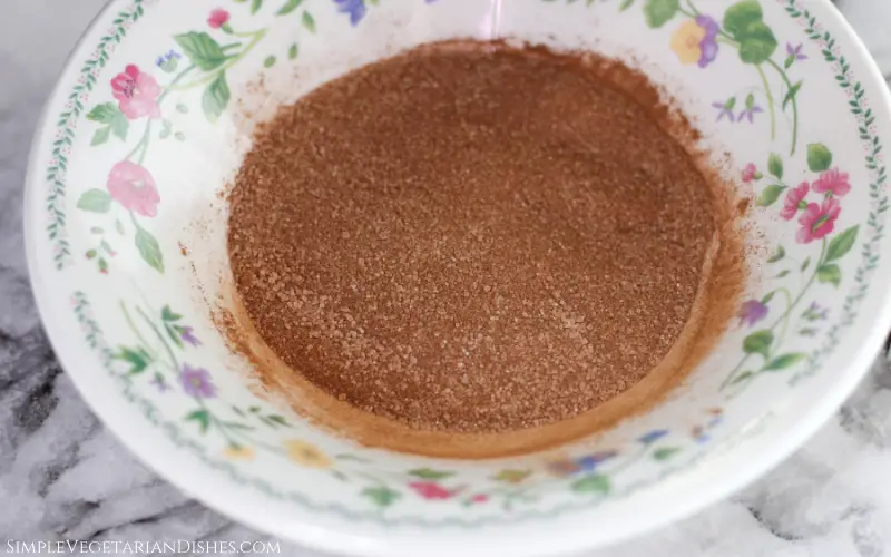 sugar and cinnamon mix in floral bowl to dip churro pancakes