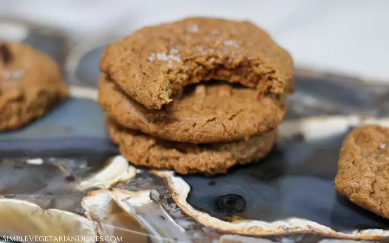 cashew butter cookies with bite taken out of top one