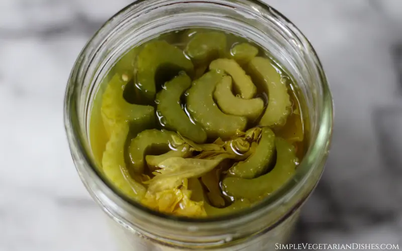 fermented celery sticks in clear glass pint jar