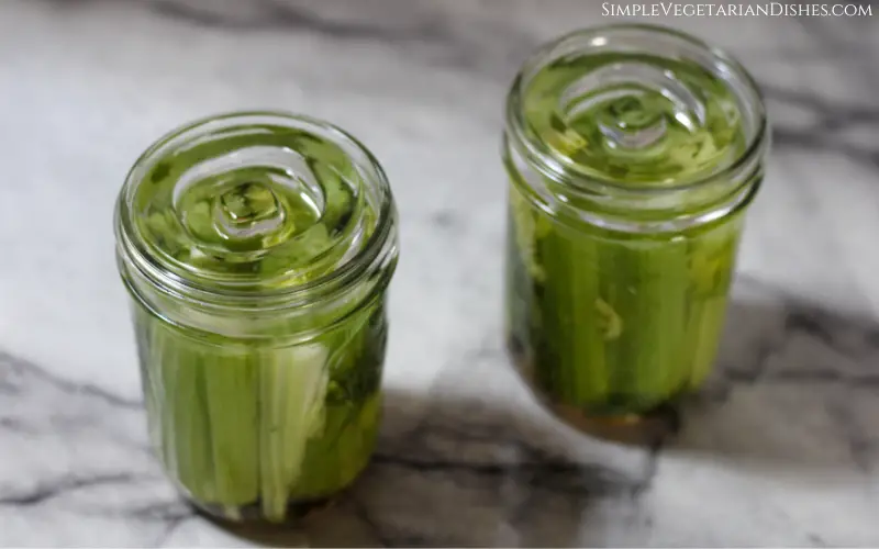 fermenting weights on jars of fermented celery in process