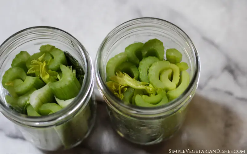 celery sticks packed into pint jars for fermenting