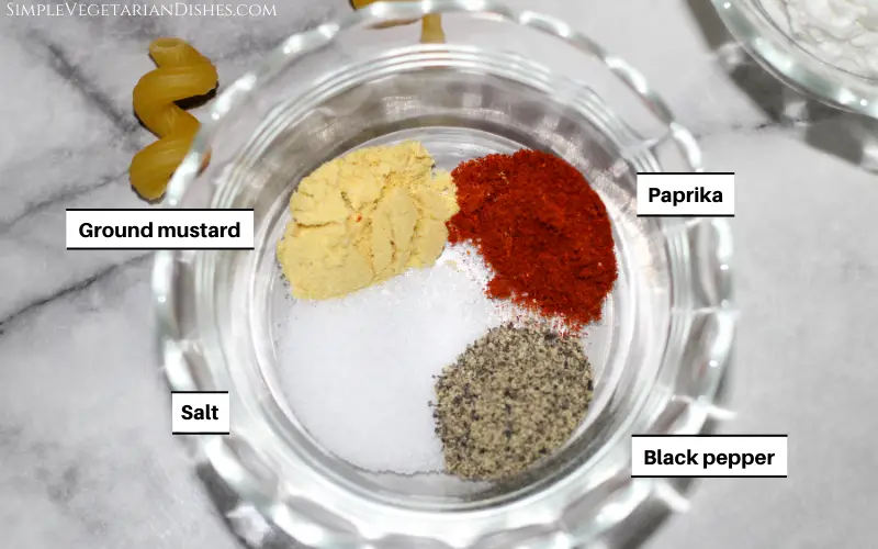 spices in small glass bowl mustard paprika salt pepper