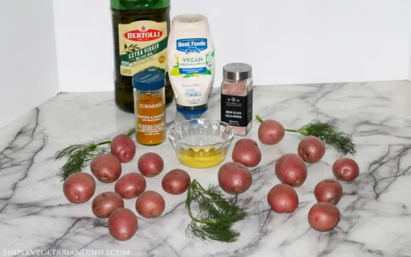 ingredients to make deviled potatoes arrayed on white marble table