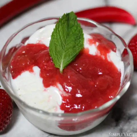 ice cream with strawberry rhubarb sauce and mint leaf garnish