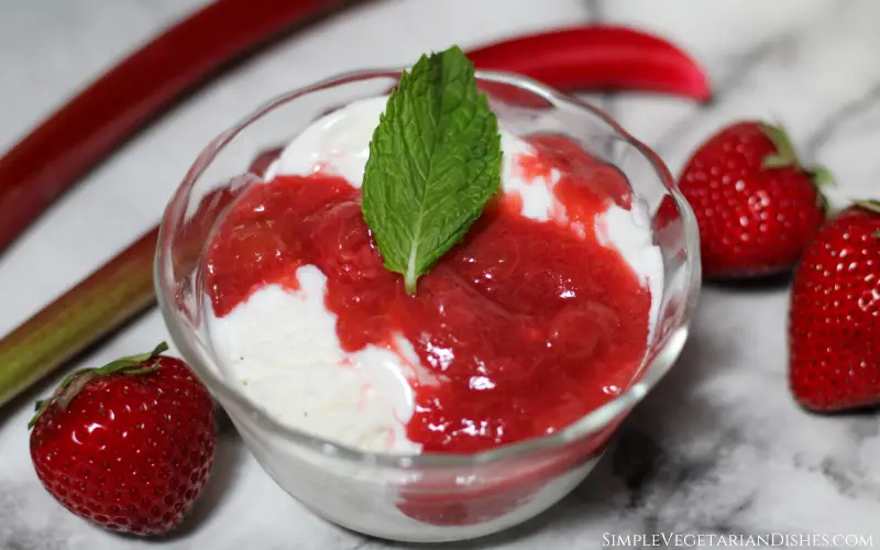 ice cream with strawberry rhubarb sauce and mint leaf garnish