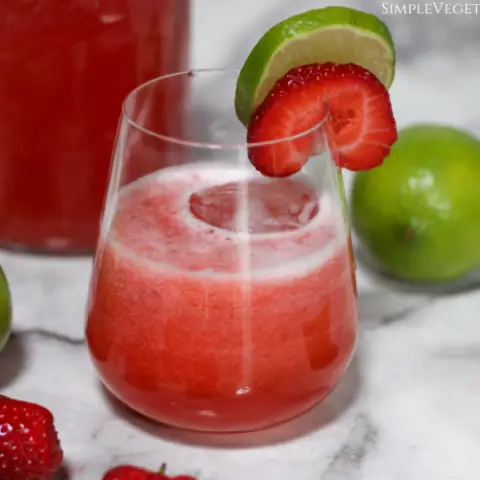 strawberry limeade served with slices of lime and strawberry to garnish
