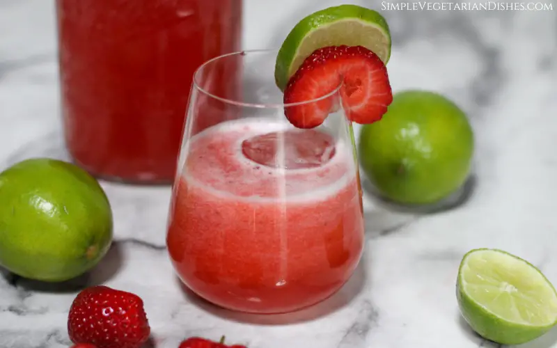 strawberry limeade served with slices of lime and strawberry to garnish