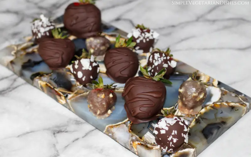 vegan chocolate covered strawberries served on gray agate cheese tray
