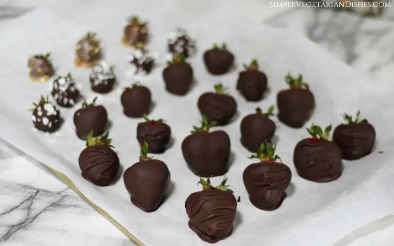 tray of vegan chocolate covered strawberries done on parchment paper