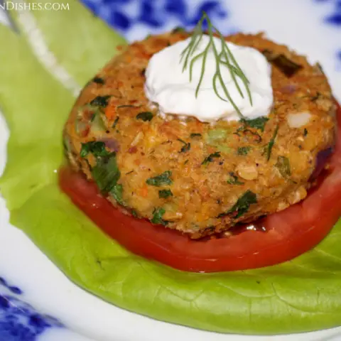 chickpea patty on tomato and lettuce with yogurt and dill