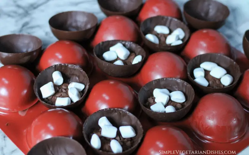 vegan hot chocolate bomb half shells filled with hot cocoa mix and mini vegan marshmallows