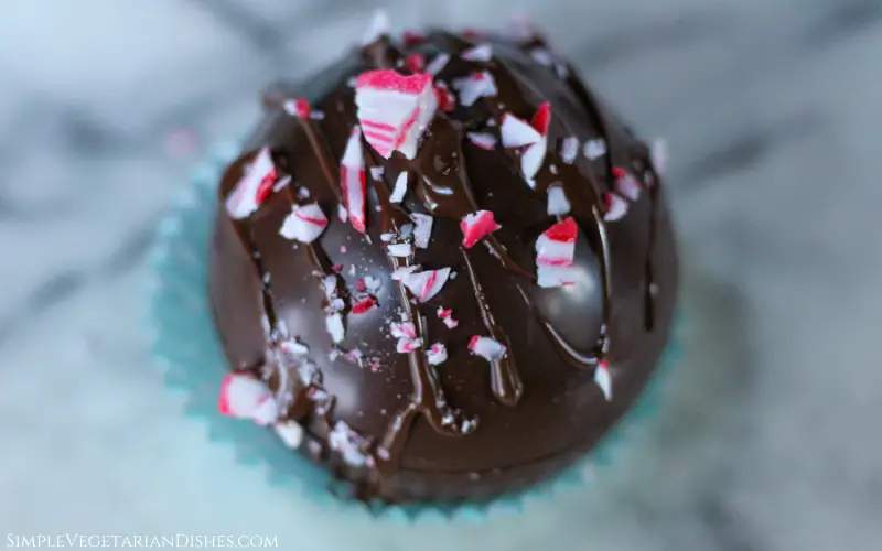 vegan hot chocolate bomb close up with crushed candy cane