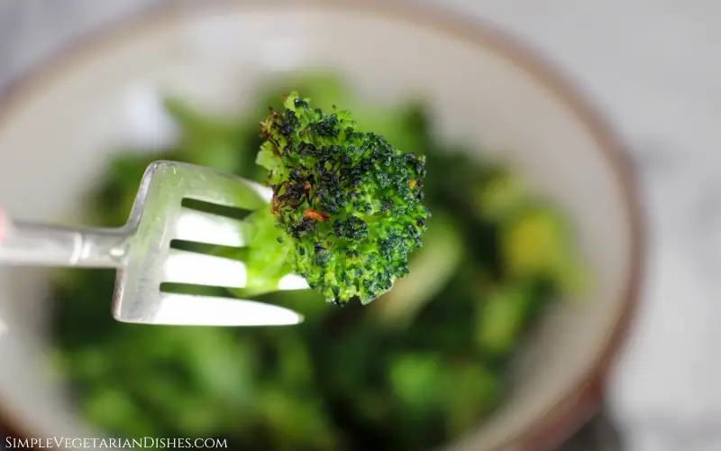 floret of frozen broccoli cooked in the air fryer on a fork