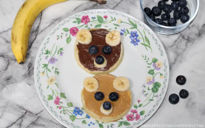 two teddy bear waffles on white floral plate