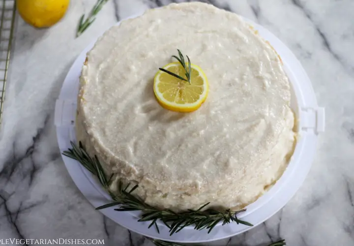round lemon rosemary cake garnish with lemon slice and fresh rosemary