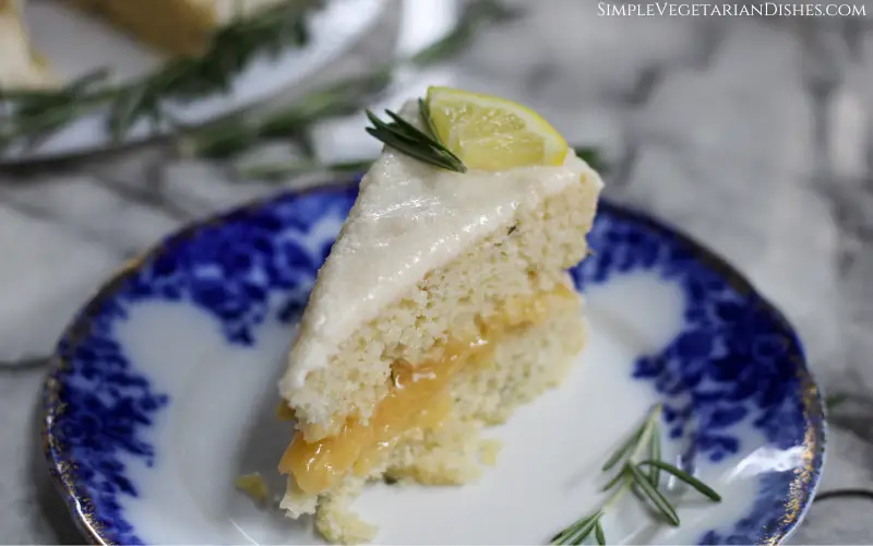 slice of lemon rosemary cake served on blue china plate