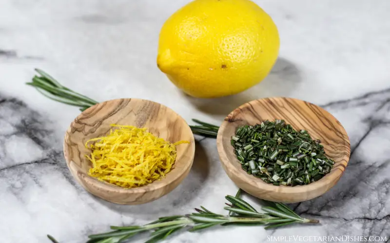 olive wood bowls of lemon zest and chopped rosemary