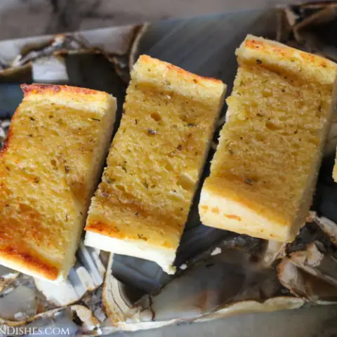 frozen garlic bread in air fryer served on gray agate cheese board
