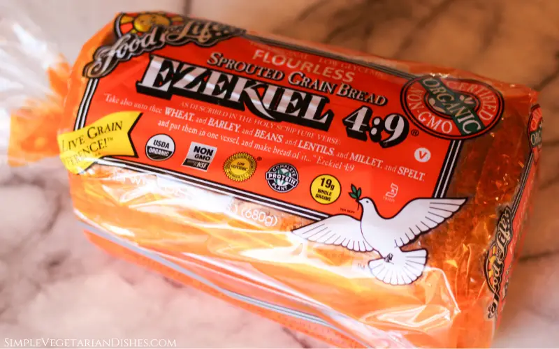 is Ezekiel bread keto cover image loaf in orange plastic bag on white marble table