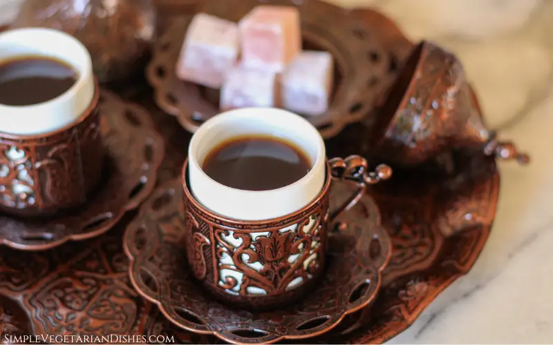 two cups of Turkish coffee on tray with Turkish delight in background