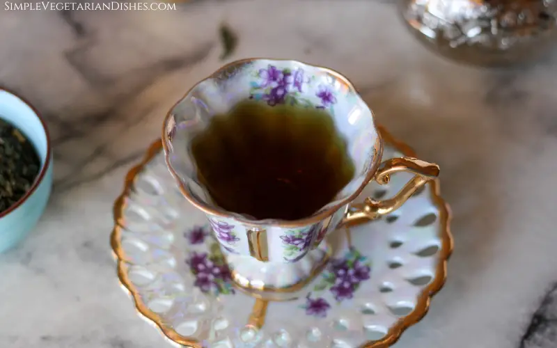 ceramic floral cup on saucer filled with liquid